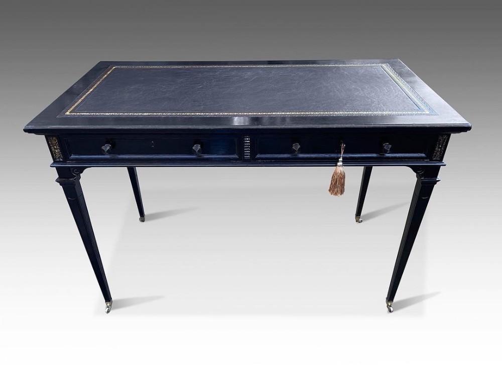 an elegant french ebonised writing table